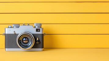 Retro camera on yellow background photo