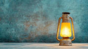 vintage lantern glowing softly against textured blue background photo