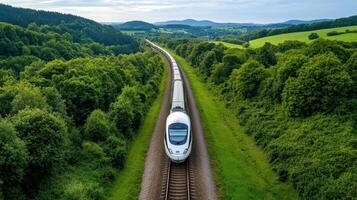 High speed train traveling through lush green countryside photo