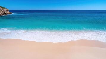 A beach with a clear blue sky and a sandy beach photo