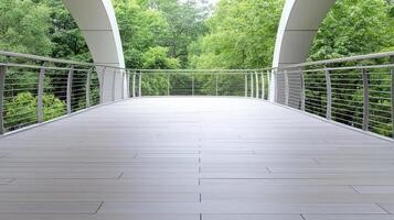 A bridge with a railing and a green forest in the background photo