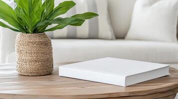 White book on round table with vase of plant photo