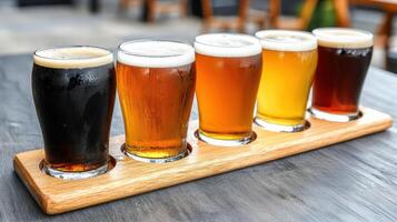 Five different types of beer are on a wooden tray photo