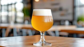 A glass of beer sitting on a table photo