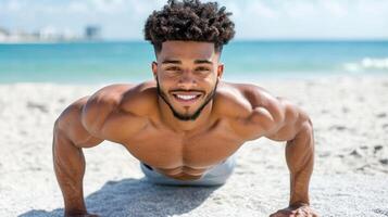 A man is smiling while doing push ups on the beach photo