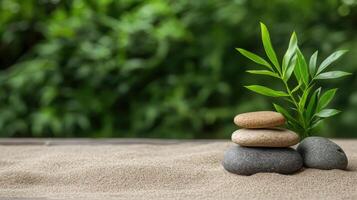 Zen stones and bamboo plant on sand background photo