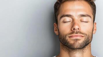 A man with his eyes closed and his head tilted up photo