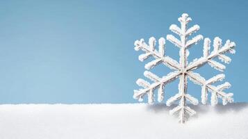 A snowflake is sitting on top of a blue sky photo