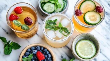 A variety of drinks with cucumbers, berries and mint photo