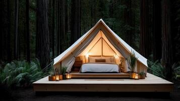 A tent in the woods with a bed and candles photo