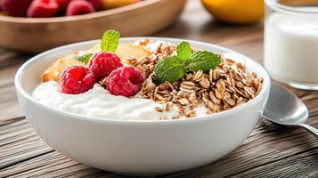 A bowl of yogurt with fruit and a spoon photo