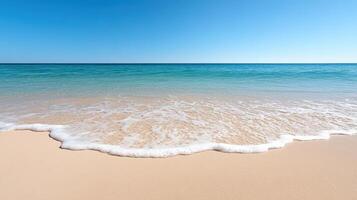 A sandy beach with waves and a blue sky photo