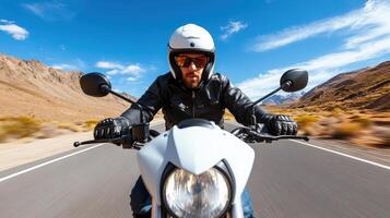 A man riding a motorcycle on a road photo