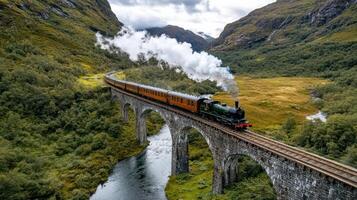 steam train crosses old stone bridge over deep valley, surrounded by lush mountains photo