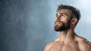 A shirtless man standing in the rain photo