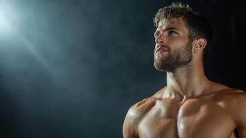 A shirtless man with no shirt on a dark background photo