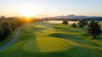 The sun rises over a golf course at sunrise photo