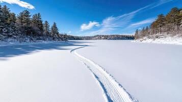 A cross country ski trail is shown on the snow photo