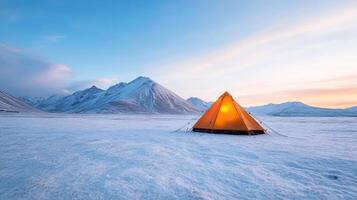 glowing tent in snowy landscape surrounded by majestic mountains creates serene atmosphere photo