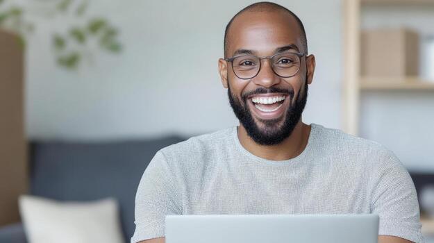 Happy man working on laptop in modern workspace, showcasing joy and productivity photo