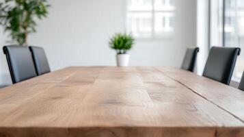 A wooden table with black chairs in front of a window photo