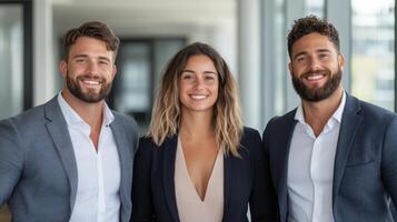 Three business people smiling in an office photo