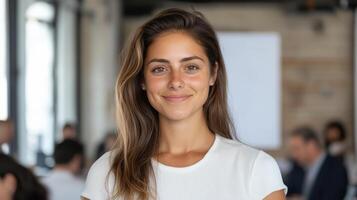 A woman in a white shirt smiling at the camera photo