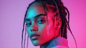 A woman with dreadlocks and pink and purple background photo