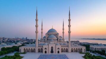 grand mosque with towering minarets and intricate architecture, bathed in sunset hues photo