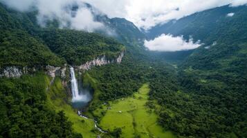 Majestic waterfall cascading down lush green mountains, surrounded by vibrant nature and clouds photo