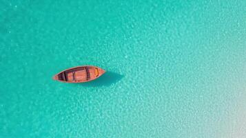 serene boat floating on clear turquoise water creates peaceful scene photo