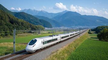High speed bullet train traveling through lush green fields and mountains in Japan photo