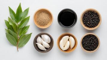 Various spices and herbs in bowls on a white surface photo