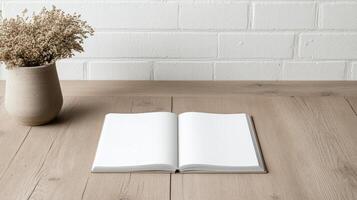 open blank book on wooden table with vase of dried flowers nearby creates serene atmosphere photo