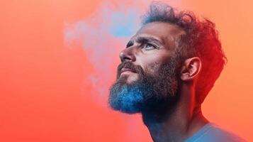 man with beard gazes upward, surrounded by colorful smoke against vibrant background photo