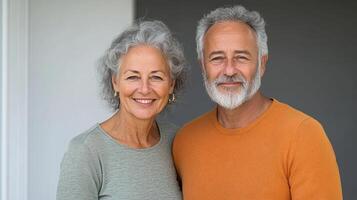 Happy retired couple enjoying their time together, smiling warmly at camera photo