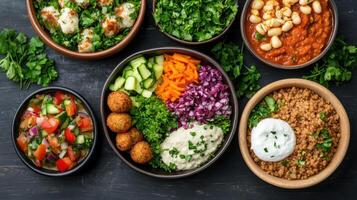 Fresh Mediterranean dishes arranged in bowls, featuring vibrant vegetables and dips photo