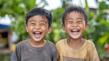 Happy children laughing together in green outdoor setting, showcasing joy and friendship photo