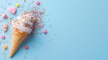 Delicious ice cream cone topped with colorful sprinkles and candy on blue background photo