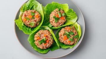 Lettuce wraps with meat and vegetables on a gray plate photo