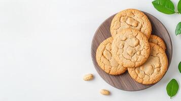 A plate with cookies and leaves on a white background photo