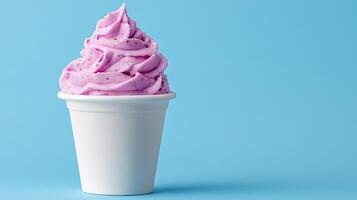 A pink ice cream sundae in a cup on a blue background photo