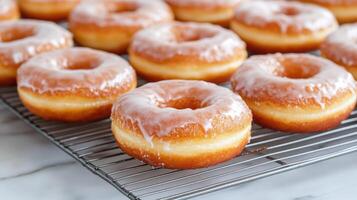 Glazed donuts on a cooling rack photo