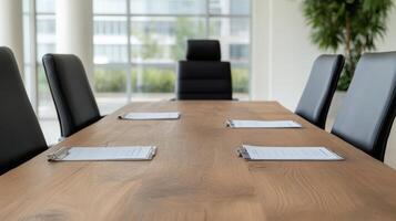 modern conference room with large wooden table, black chairs, and documents ready for discussion photo