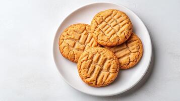 Delicious peanut butter cookies arranged on white plate, inviting and warm photo