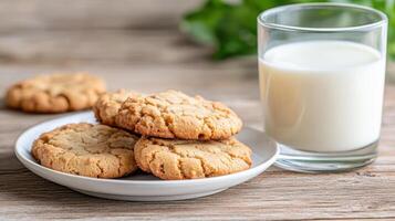 Delicious cookies on plate with glass of milk, perfect for snack or dessert photo