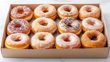 Fresh assorted donuts in box, featuring various glazes and toppings, perfect for sharing photo