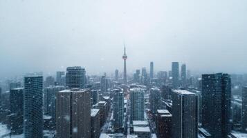 Snowy cityscape with tall buildings and prominent tower in distance, creating serene atmosphere photo