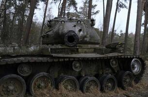 Looing down the barrel of a tank from the second World War in a forest in Western Germany photo