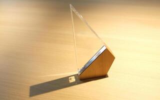 award made of glass and wood on a table with spotlights photo
